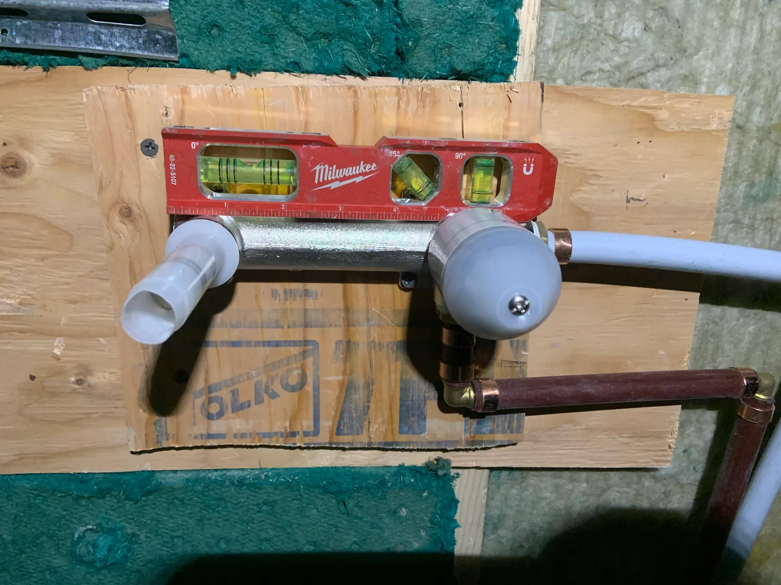 Shower valve set level on plywood backing, connected in copper and PEX before the wall is finished.